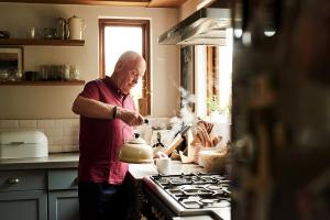 Man using gas hob and kettle